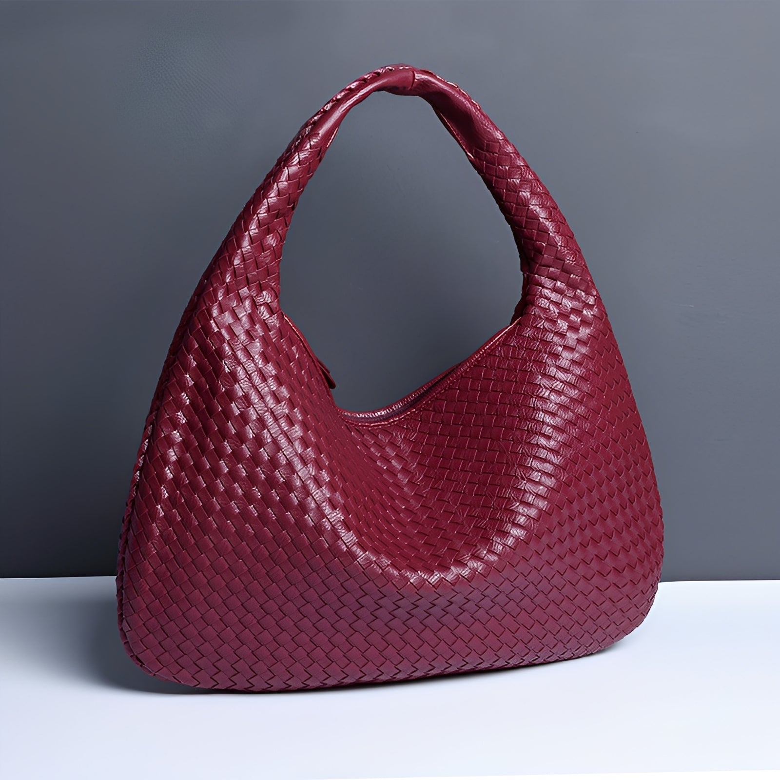 Close-up of woven faux leather texture on women's shoulder bag