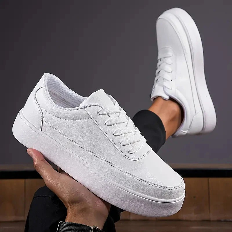 Men's white minimalist sneakers with smooth synthetic upper and rubber sole, side profile view