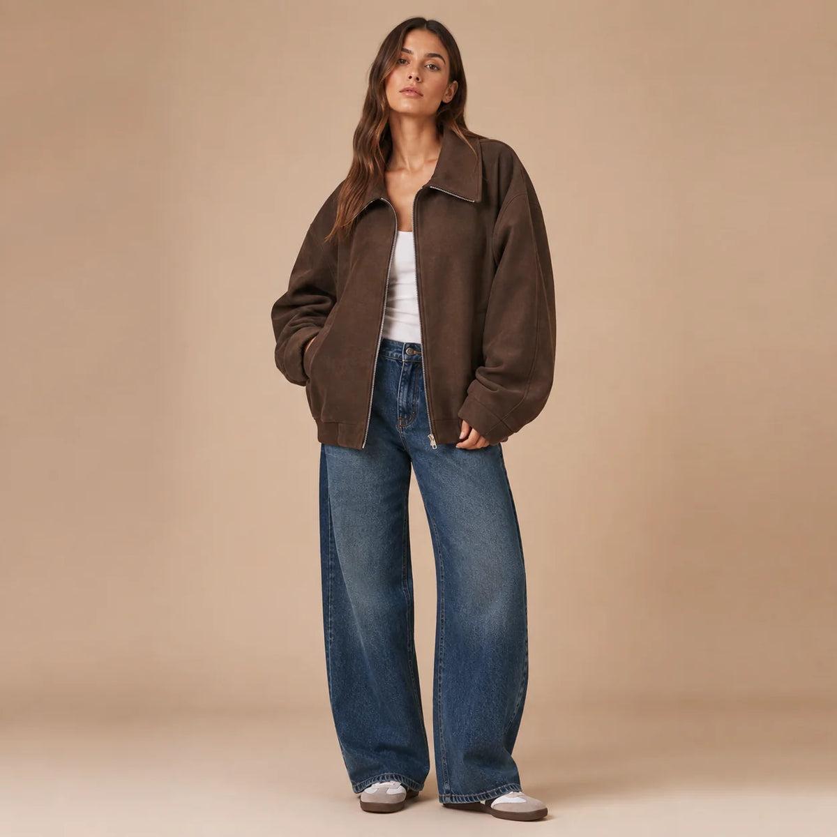 Woman wearing brown loose fit jacket with jeans full body view