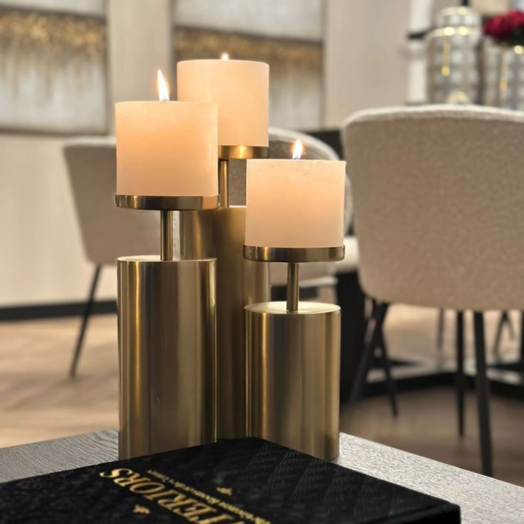 Brass candlestick set of three pillar holders in varying heights styled as a decorative centerpiece