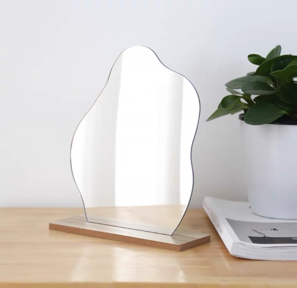 Decorative frameless mirror with irregular shape and wooden base styled in a modern interior