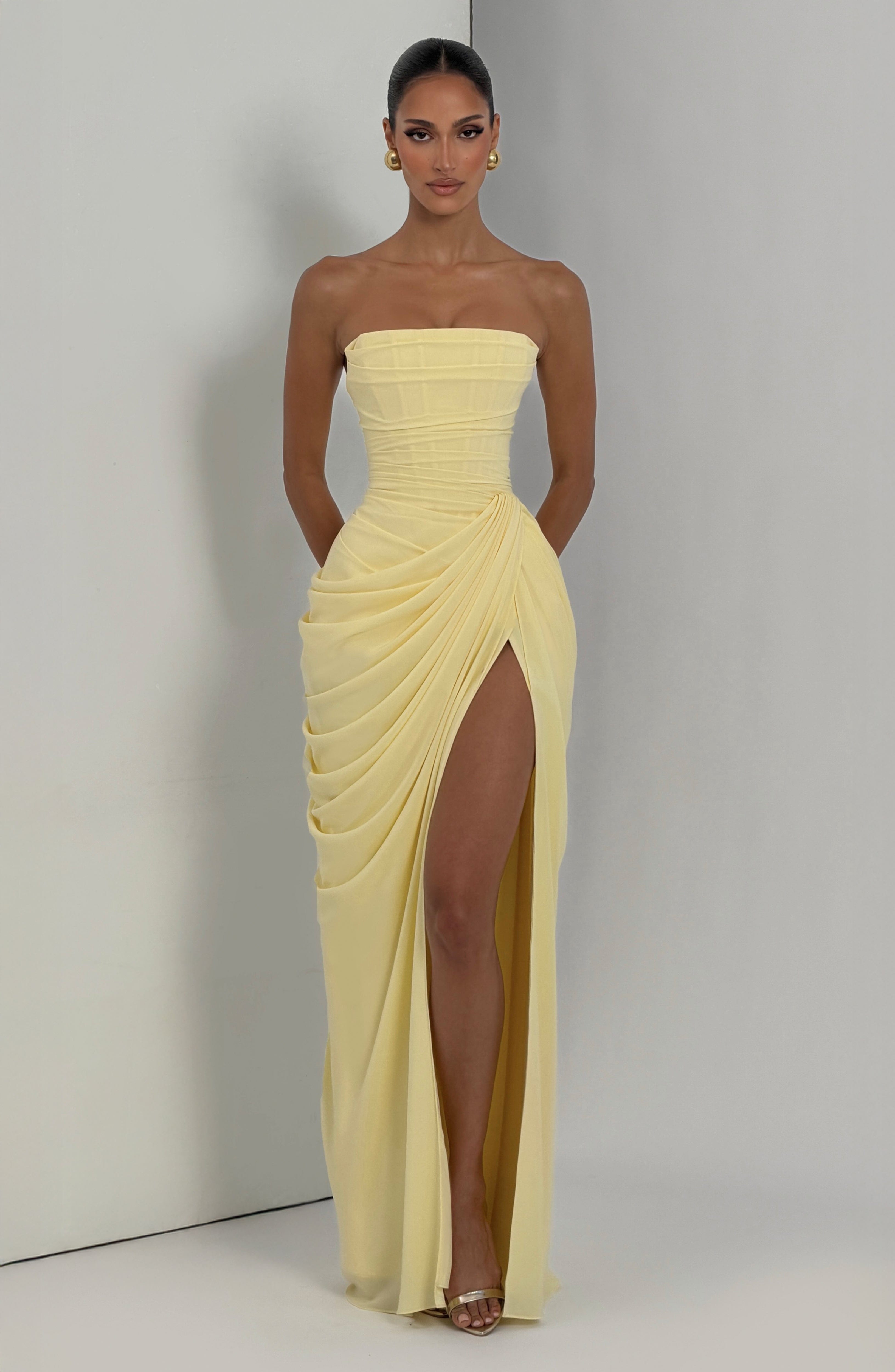 Strapless draped maxi dress with structured bodice and elegant full-length drape