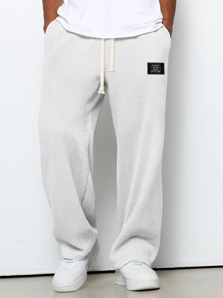 Relaxed-fit men's waffle-knit trousers with adjustable waistband, full-length leg