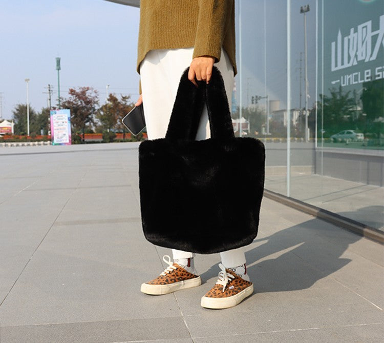 Women's faux fur tote bag side profile showing handle length and bag depth