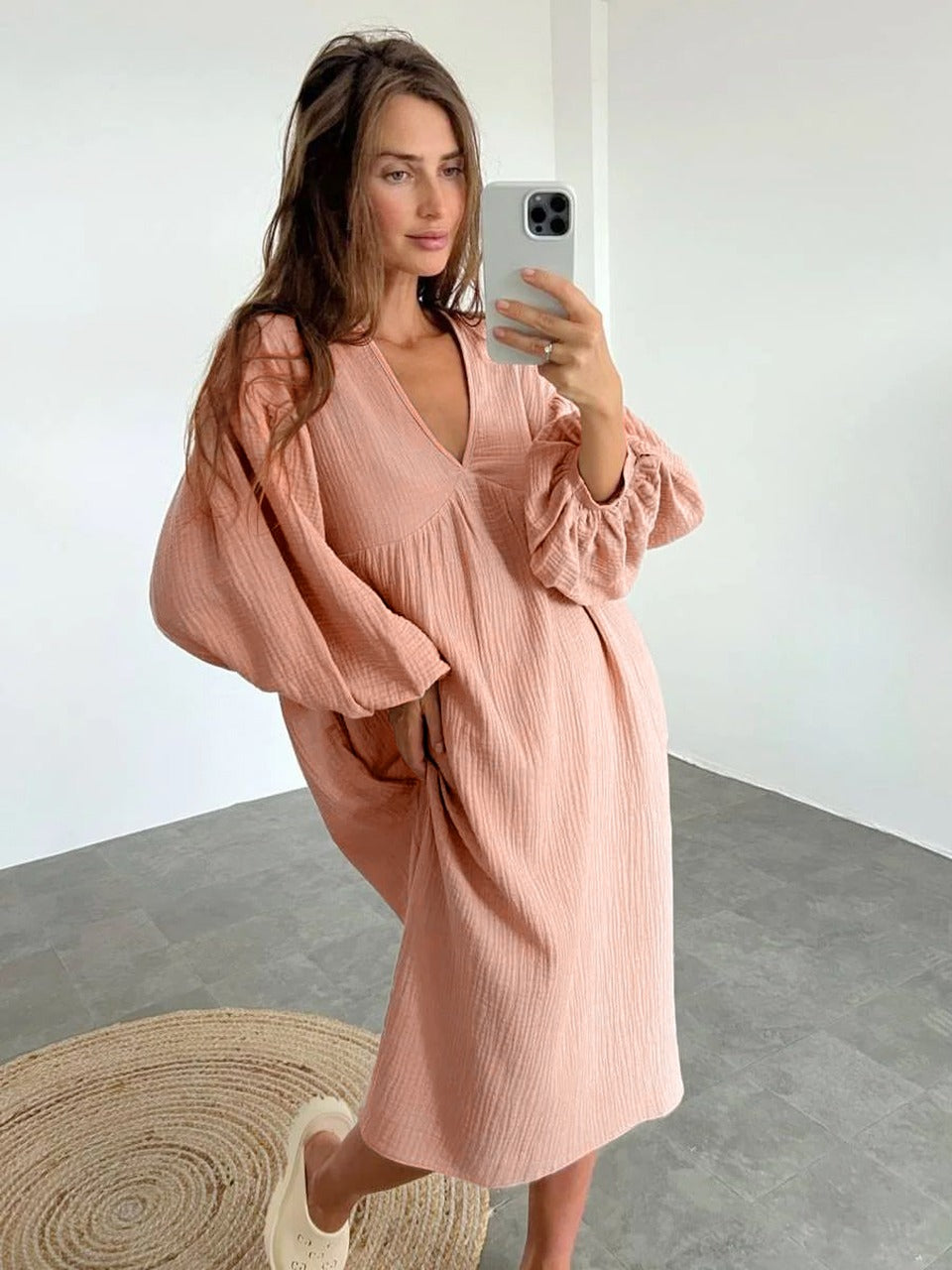 Women's long-sleeve midi dress with V-neckline and loose silhouette, lightly structured fabric