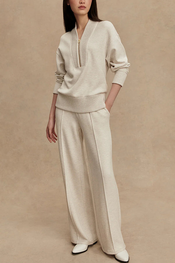 Women's two-piece knitted lounge set featuring a zip neck top and matching wide-leg trousers
