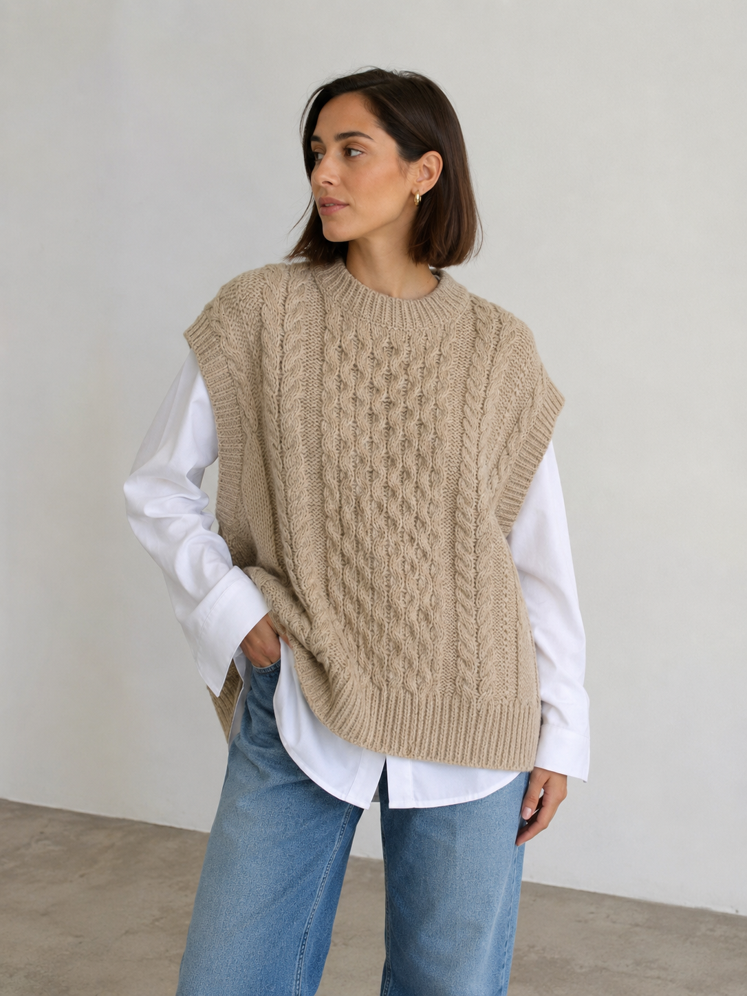 Women's cable knit sleeveless sweater with ribbed hem and relaxed fit, front view