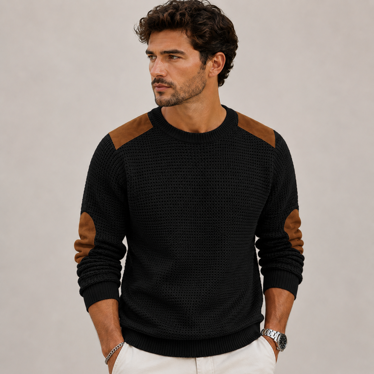 Close-up of men's crew neck knit sweater with structured shoulder and elbow detailing