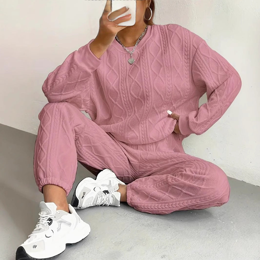 Matching knitted sweater and pants set with ribbed cable texture for women