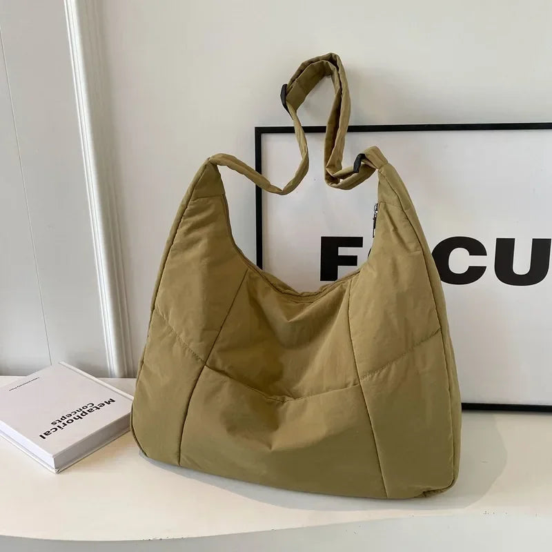 Padded shoulder bag with quilted texture and top zipper closure