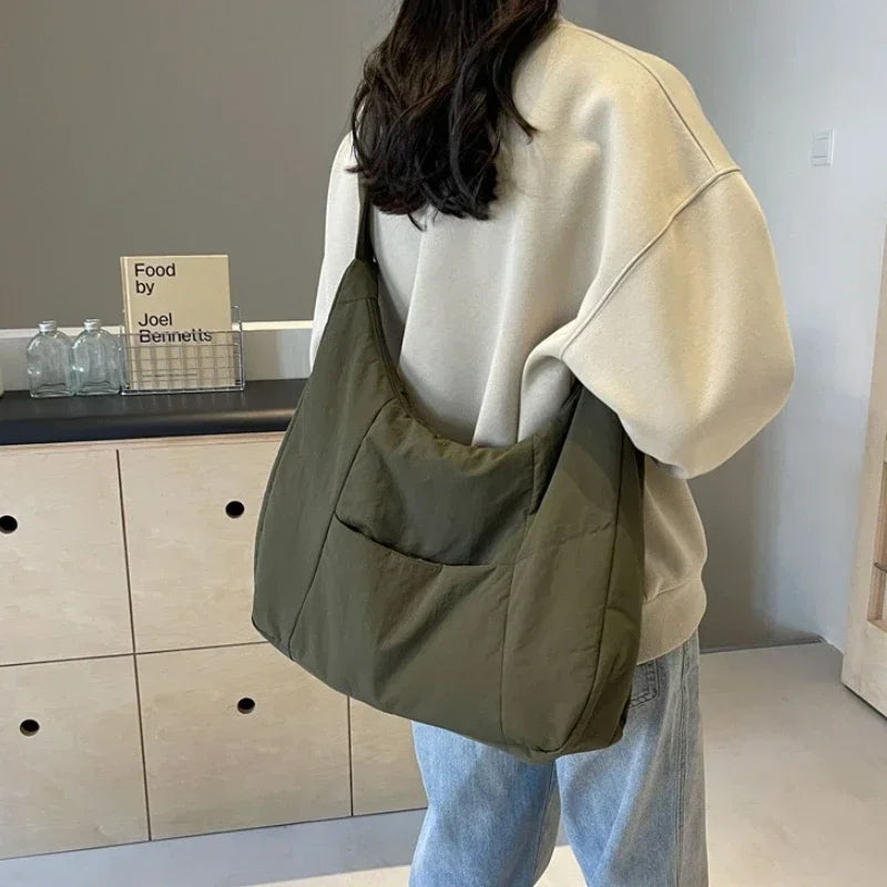 Padded shoulder bag side profile view showing strap and structure