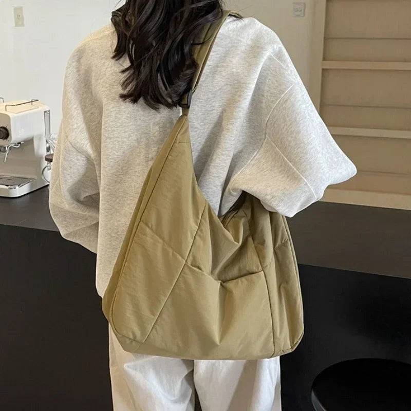 Padded shoulder bag open showing spacious main compartment