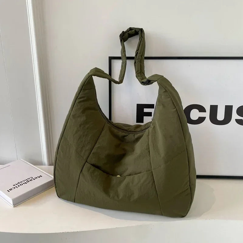 Quilted shoulder bag worn over shoulder lifestyle view