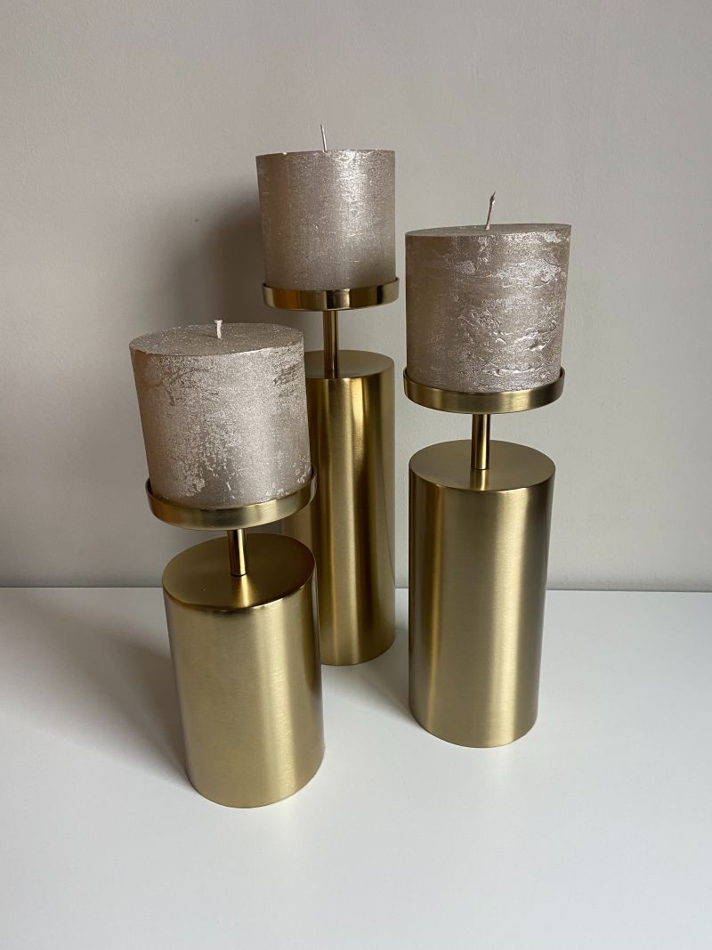 Set of three brass candlestick holders in graduated heights for Scandinavian-style interior styling