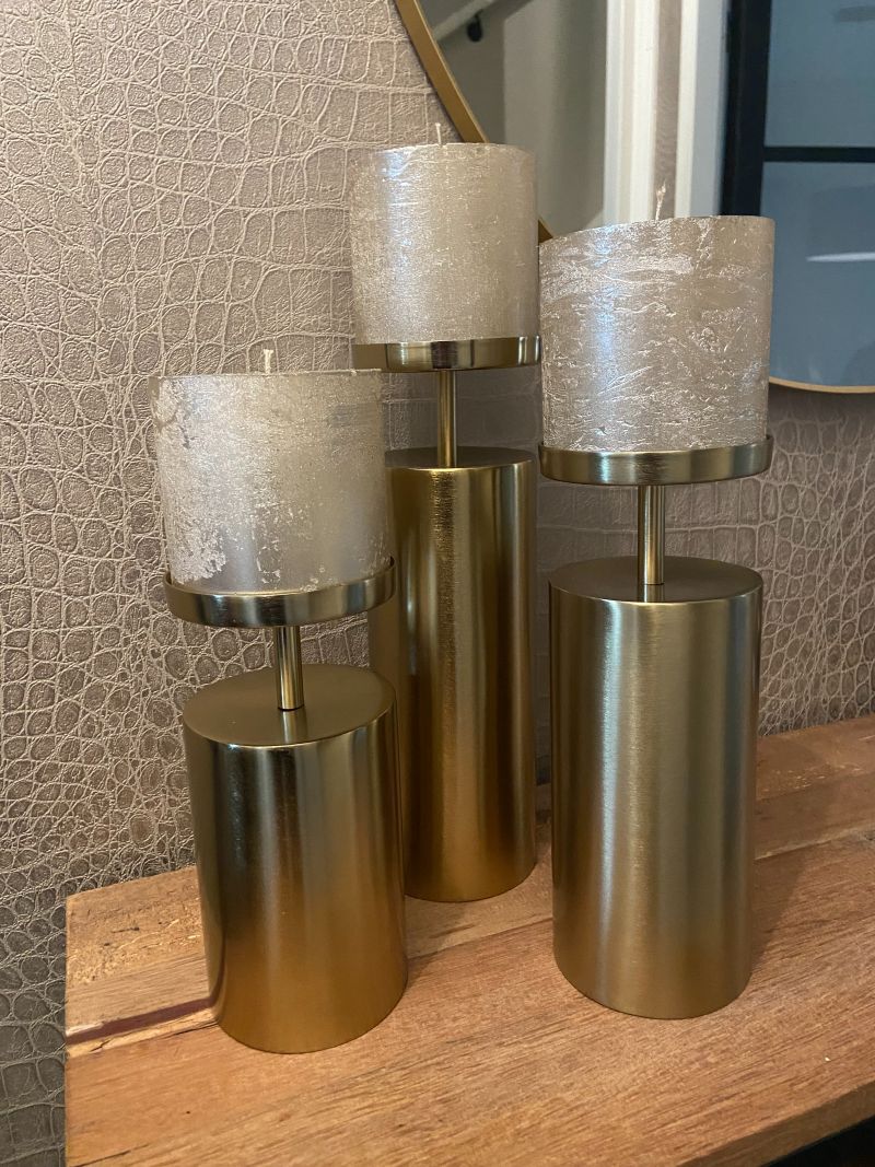 Solid brass candlestick set with brushed finish shown from a side angle highlighting height variation