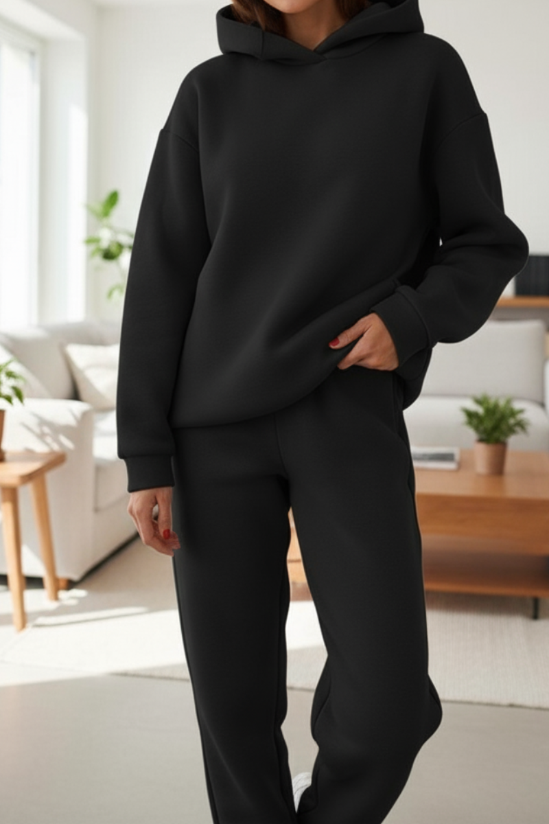 Women's two-piece jogger set, seated or relaxed pose showing fabric texture and fit