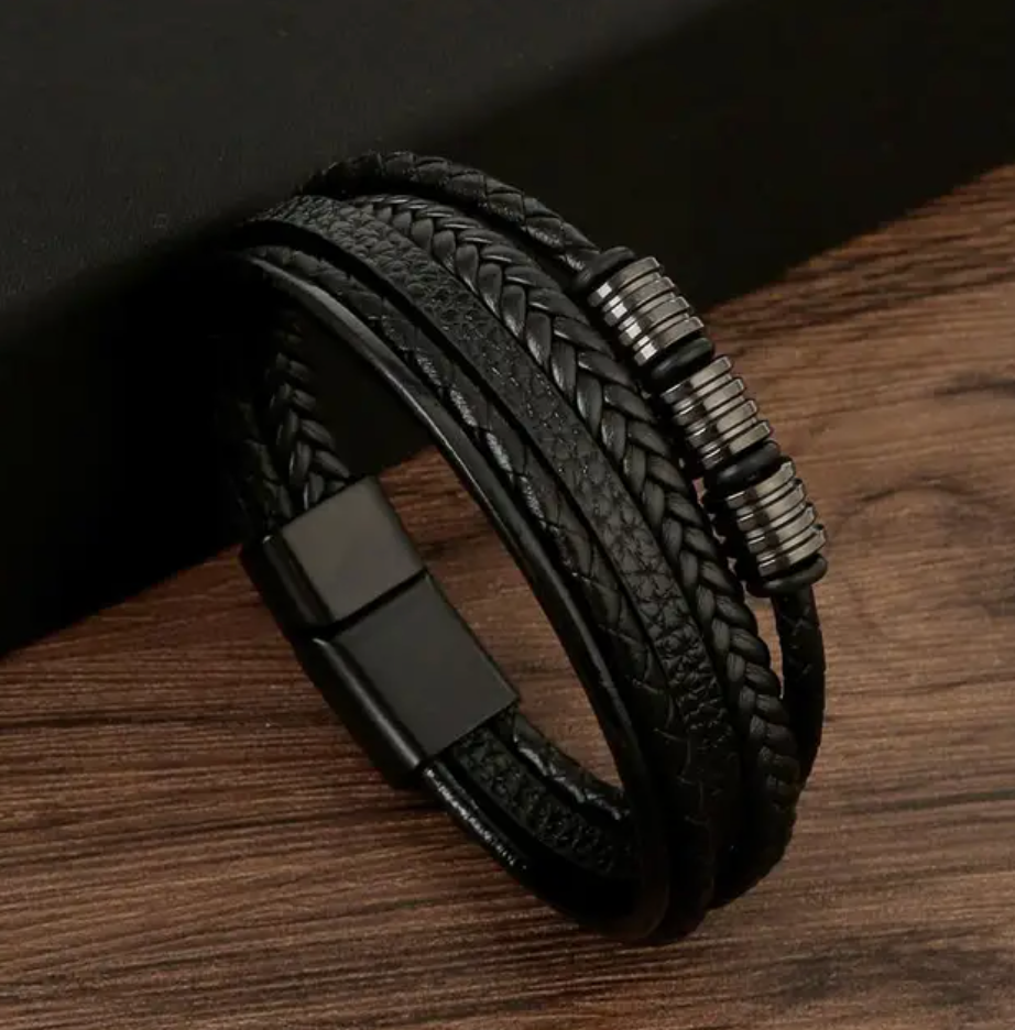 Men's multi-layer braided leather bracelet with magnetic clasp and metallic details, flat lay product view