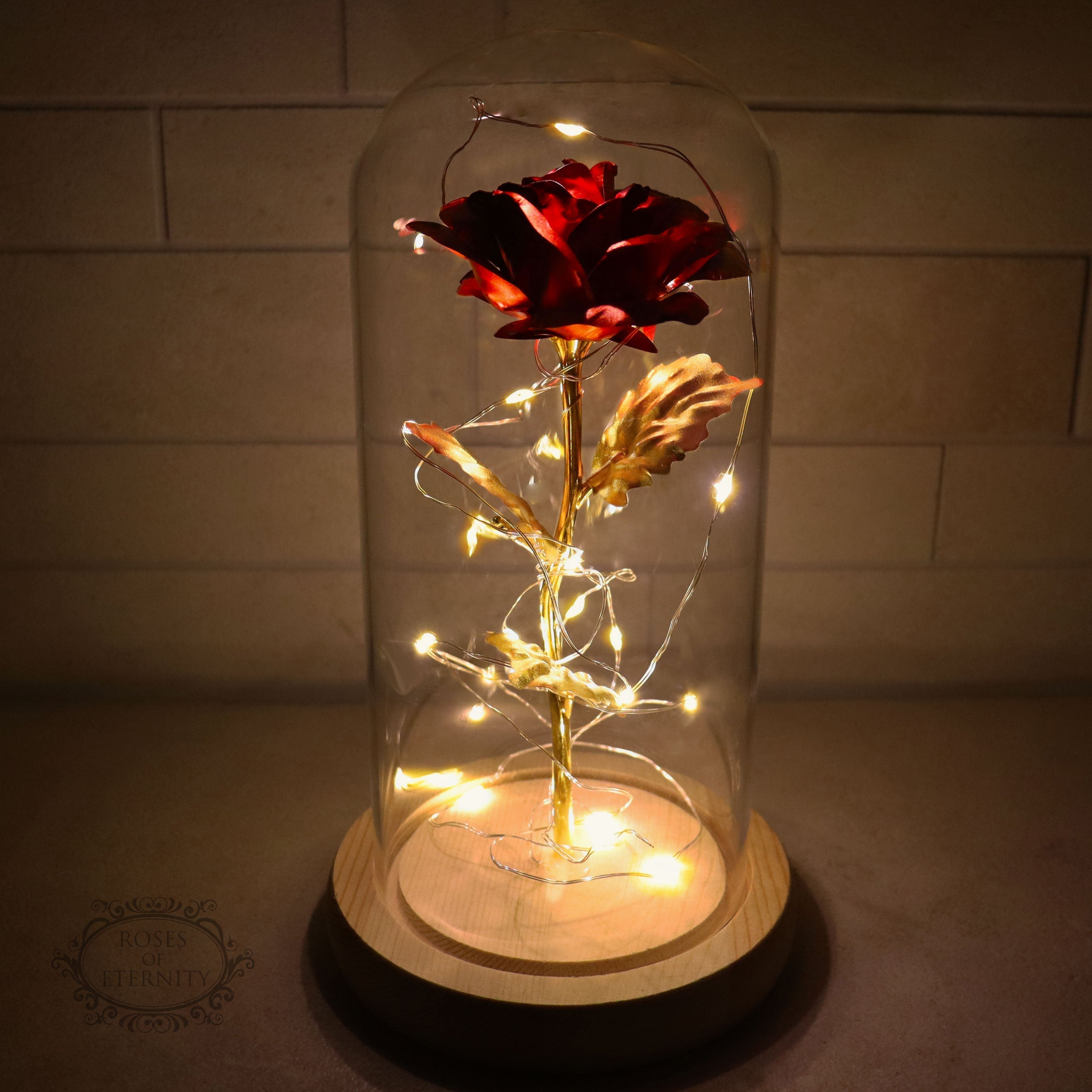 Decorative glass dome with LED flower on wooden base, warm glow accent piece for home décor