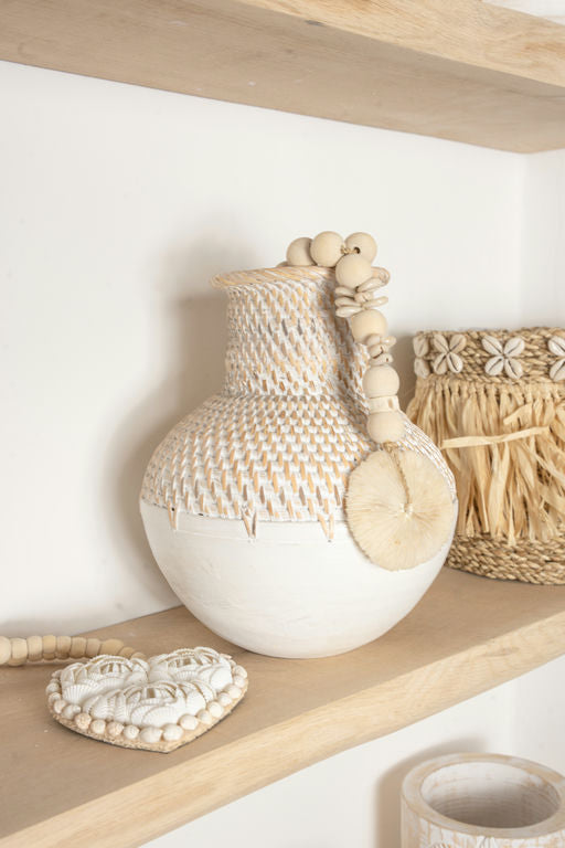 Handmade woven ceramic vase in a lifestyle home setting with soft natural light