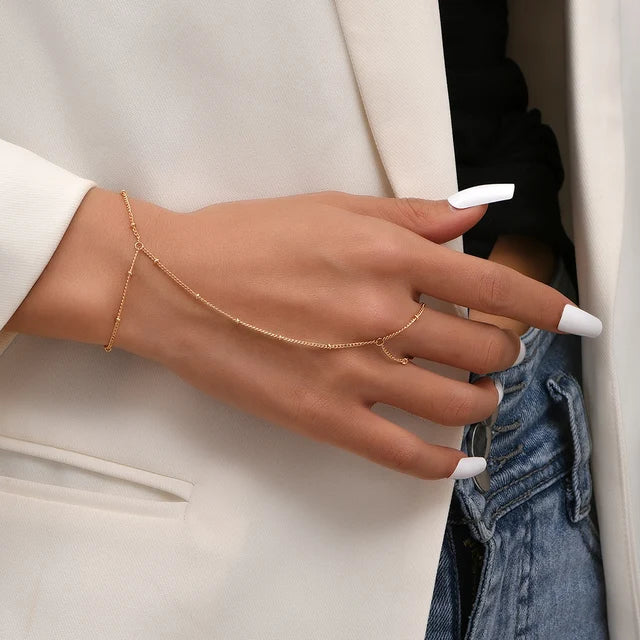 Women's hand chain bracelet with finger ring, thin metal chain links and adjustable wrist clasp