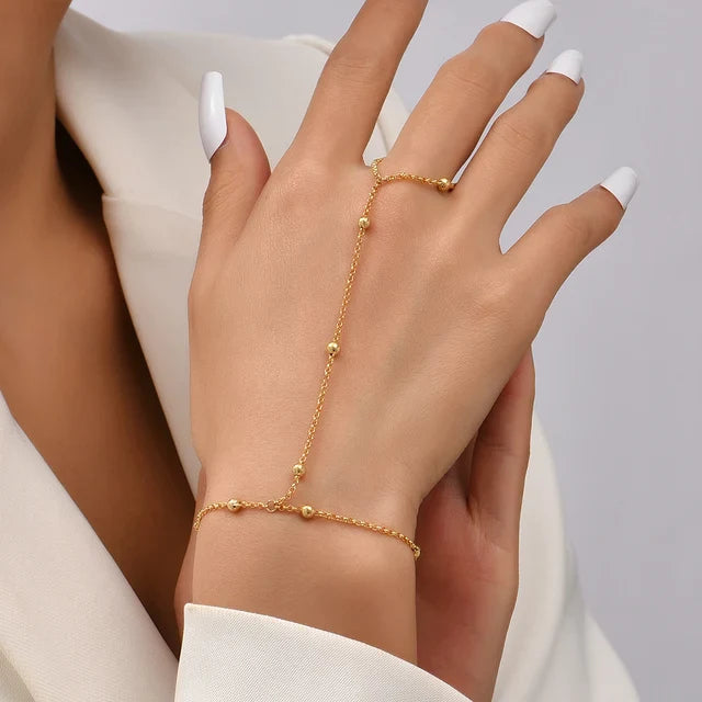 Women's metal hand chain bracelet with ring detail, adjustable fit and fine linked chain design