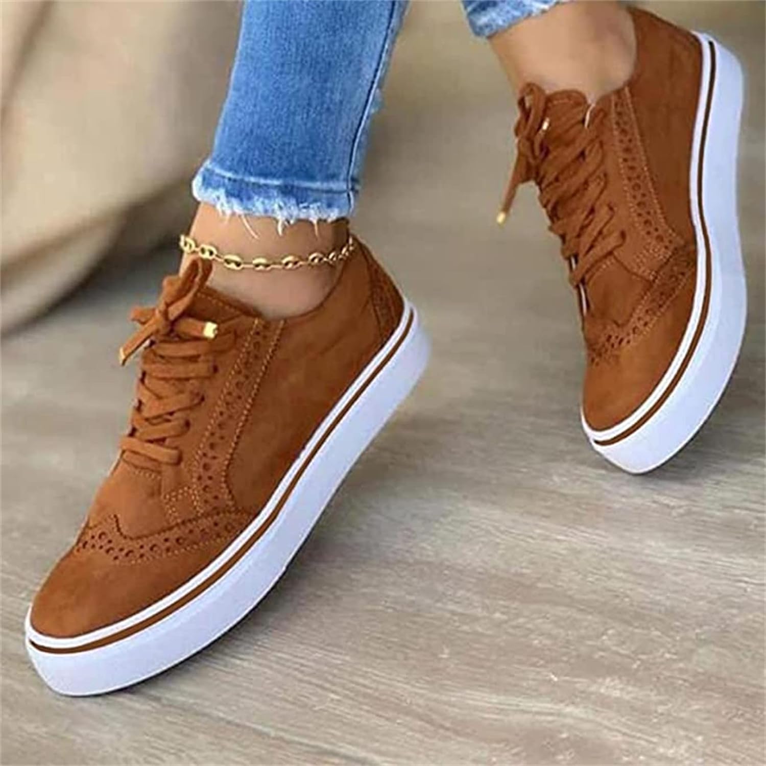 Women's lace-up sneakers with suede-like upper, perforated detailing, and rubber platform sole