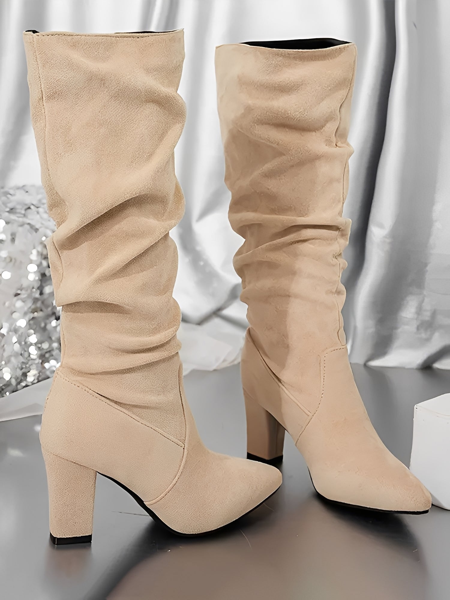 Side zipper closure detail on women's knee-high heeled boots