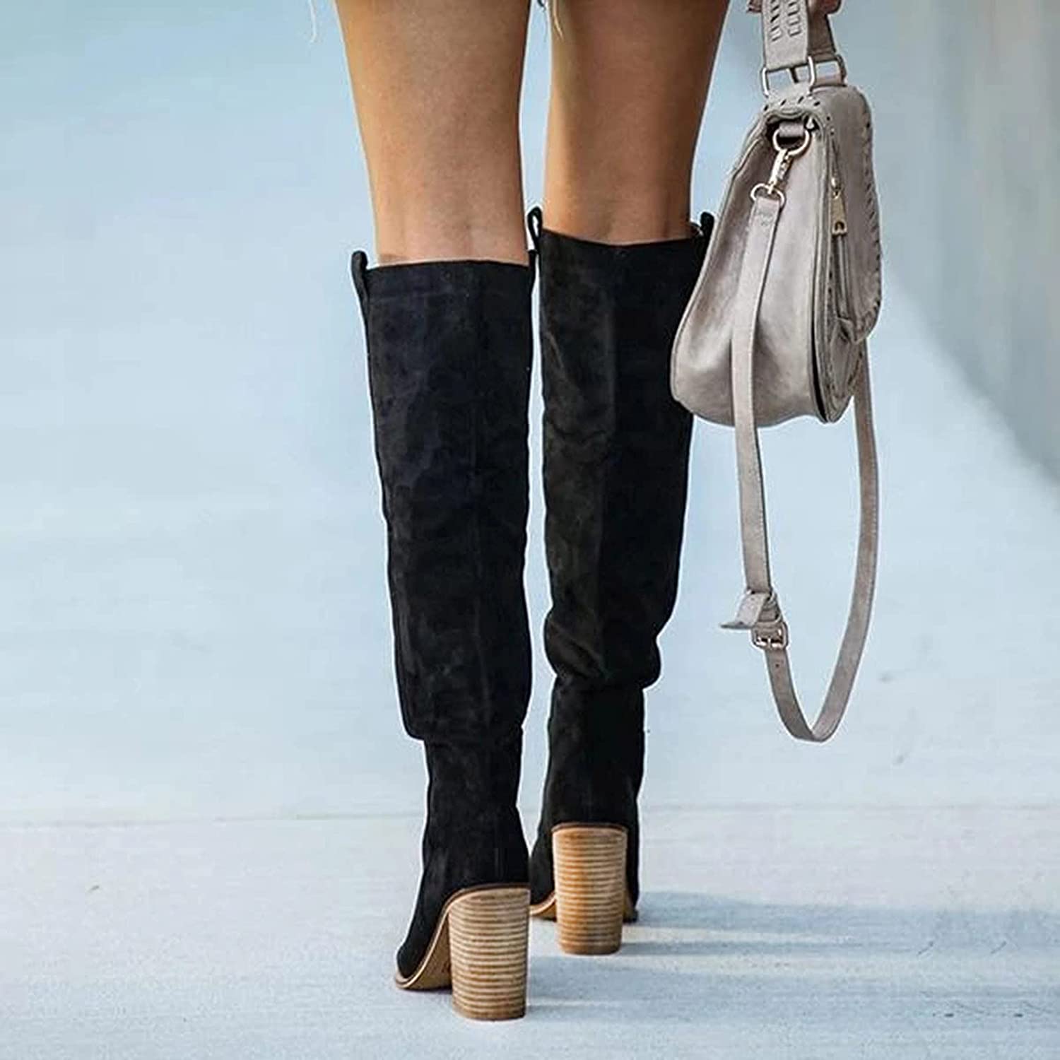 Women's knee-high boots styled on model, showing full-length silhouette