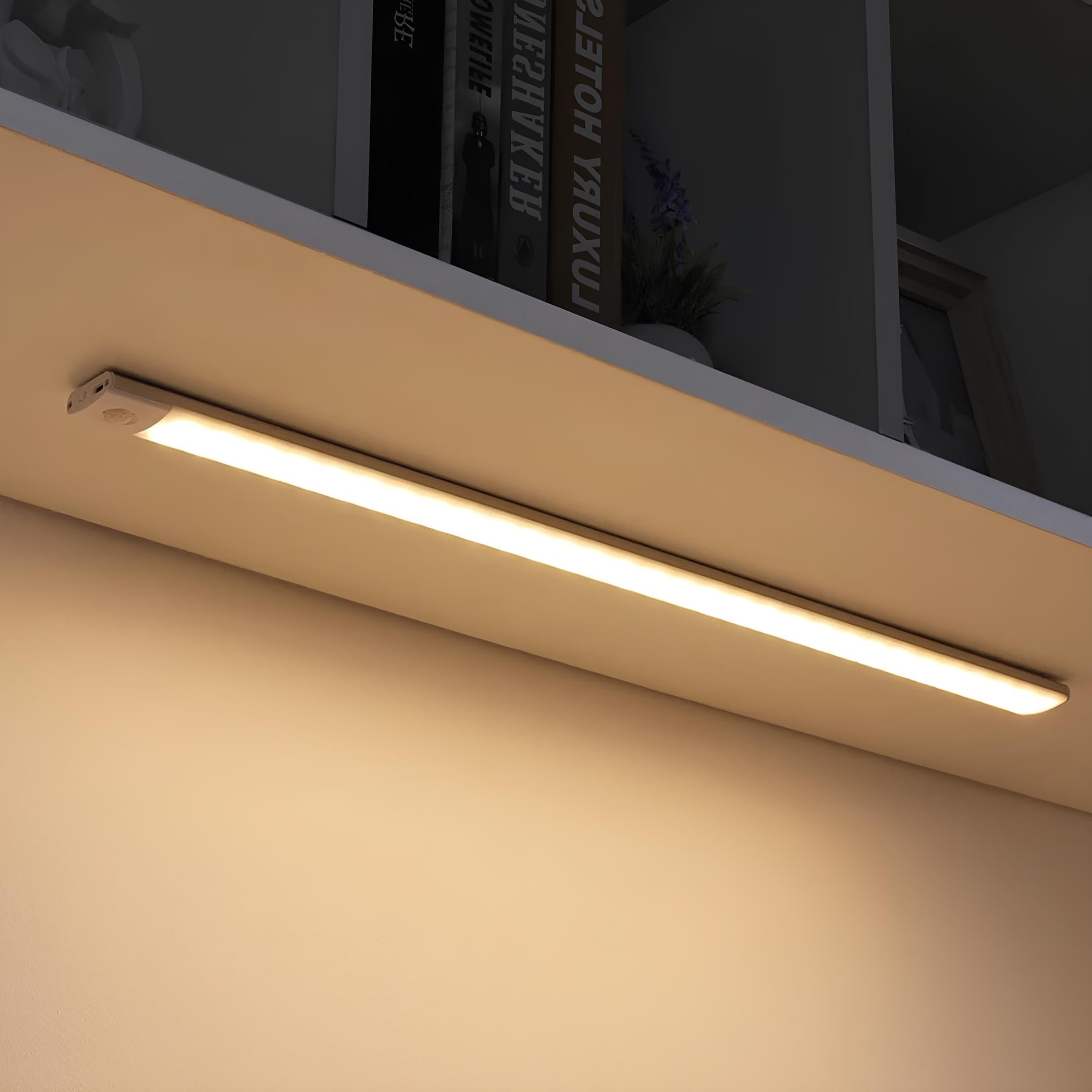 LED motion sensor lamp installed inside a cabinet showing warm glow lighting