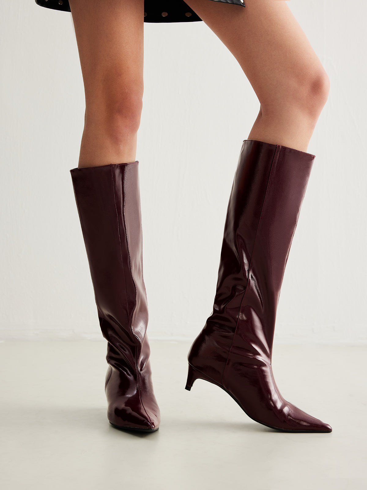 Women's knee-high faux leather boots with pointed toe and low block heel