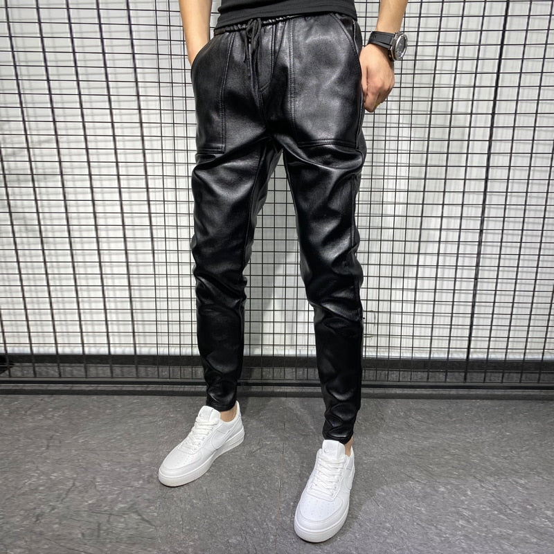 Close-up of faux leather jogger waistband with drawstring and smooth synthetic fabric