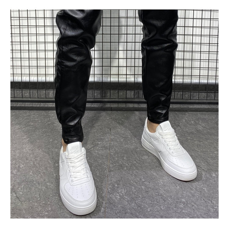 Men's faux leather joggers showing overall fit and clean synthetic leather finish