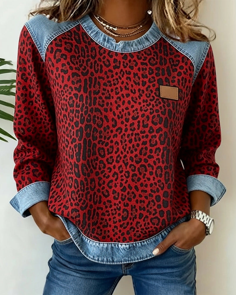 Leopard print long-sleeve top with denim trim neckline and cuffed sleeves