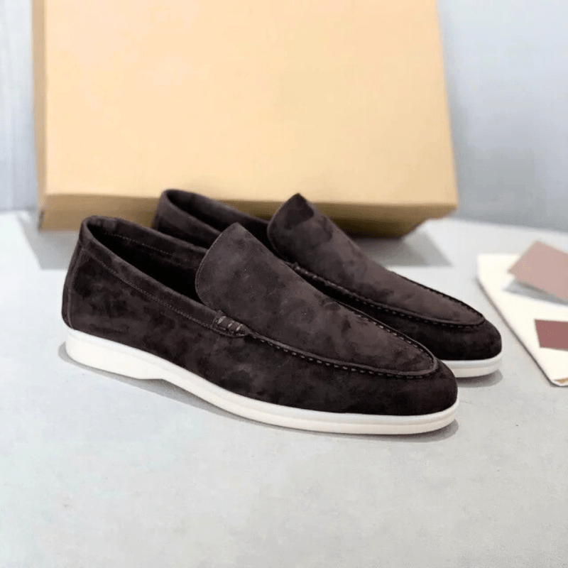 Top-down view of men's suede loafers displaying the slip-on opening and suede texture