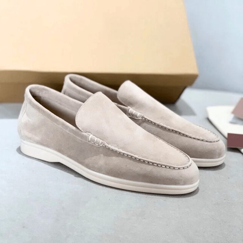 Men's suede loafers sole view showing flexible rubber outsole tread pattern