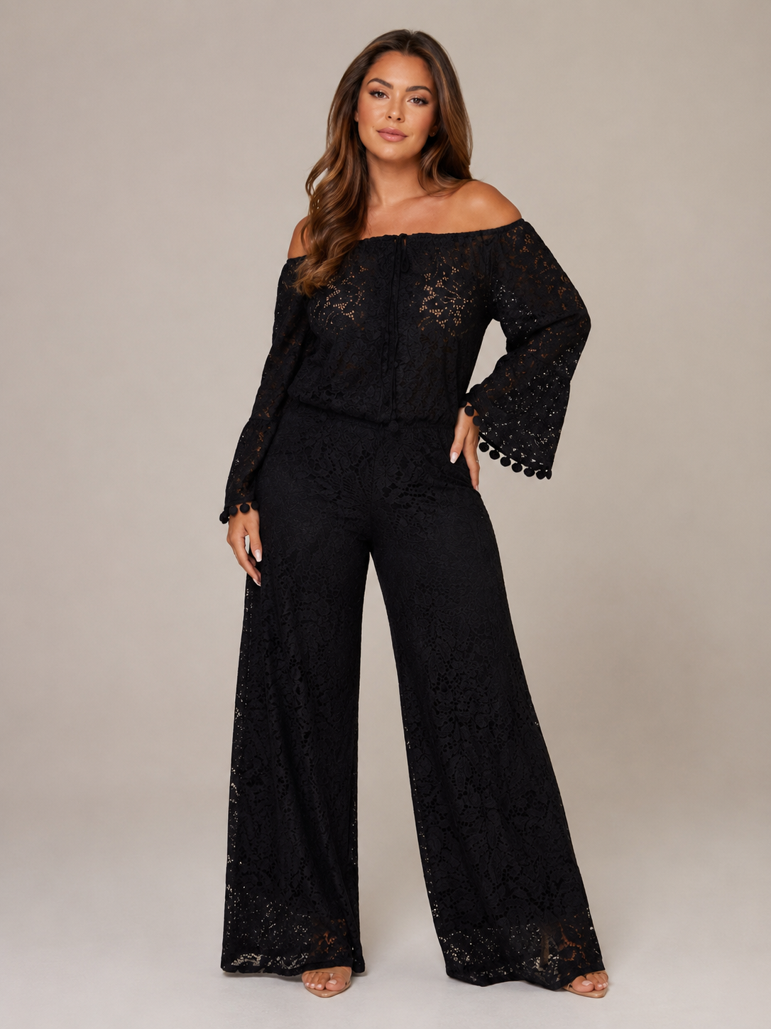 Women's black off-shoulder lace jumpsuit with long sleeves and flared legs