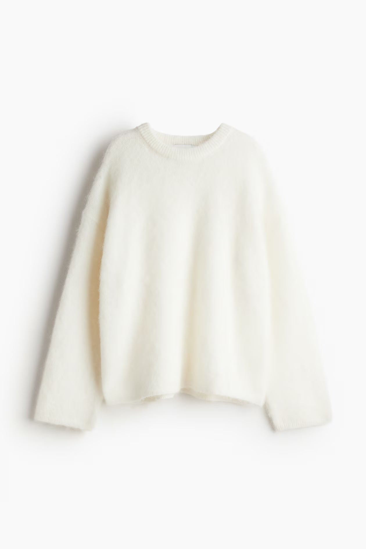 Side profile of women's soft knitted sweater with relaxed fit