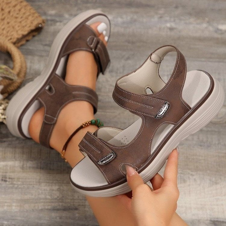 Women's flat sandals featuring Velcro-adjustable straps and structured sole