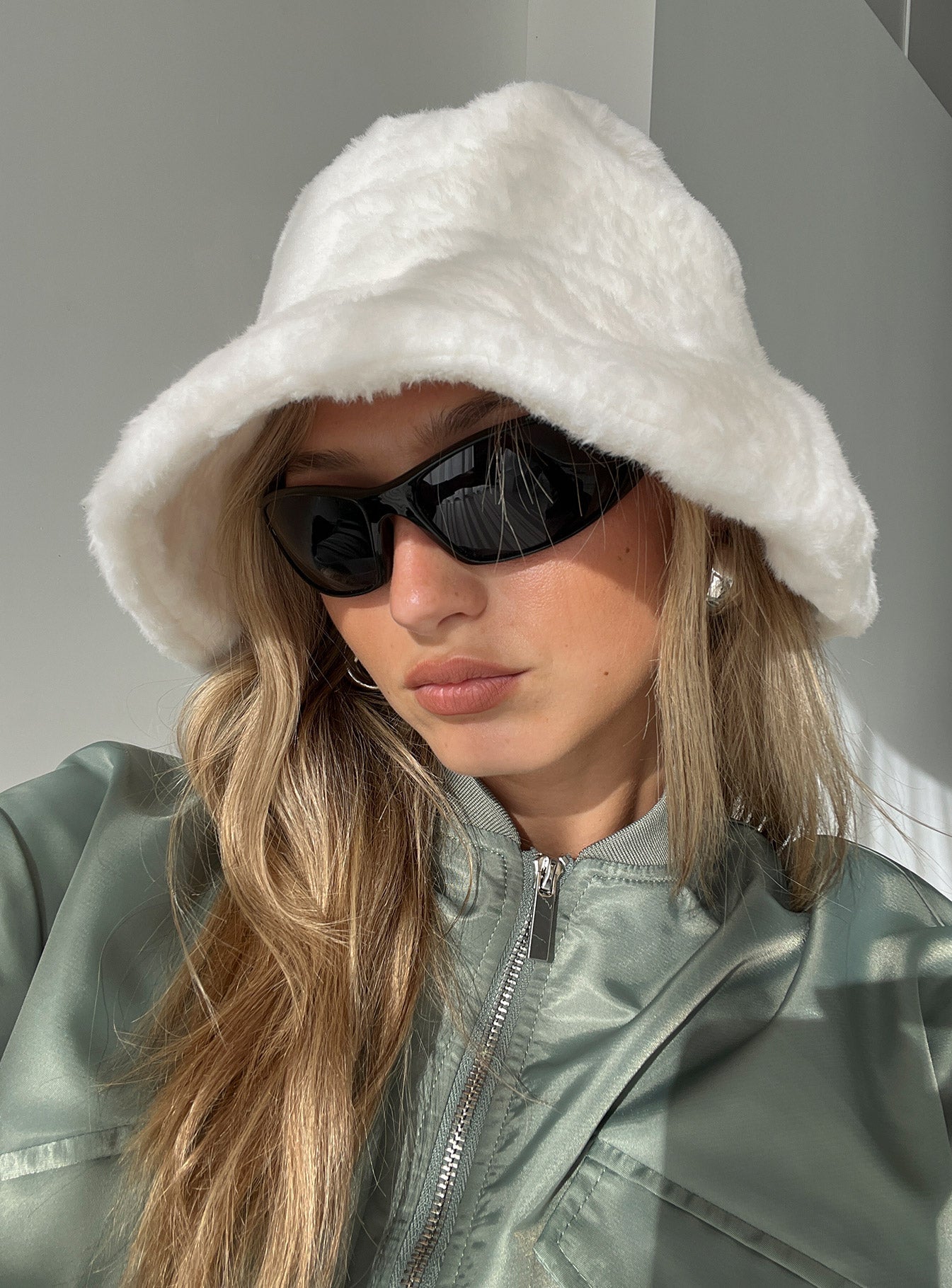 Women's faux fur bucket hat styled for autumn and winter wear, side or angled view