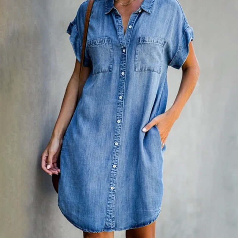 Women's short-sleeved button-up denim dress with shirt collar, chest pockets, and knee-length straight silhouette