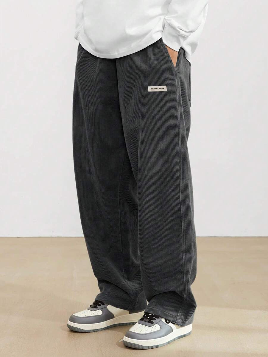 Men's wide fit corduroy trousers styled with casual top, full outfit view
