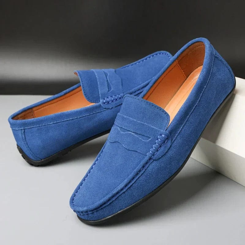 Top-down view of men's black suede loafers showing stitched toe detail