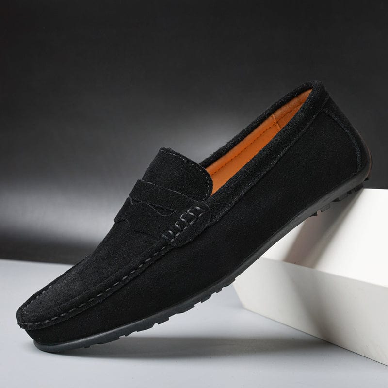Close-up of suede texture and stitching on men's black rubber-sole loafers