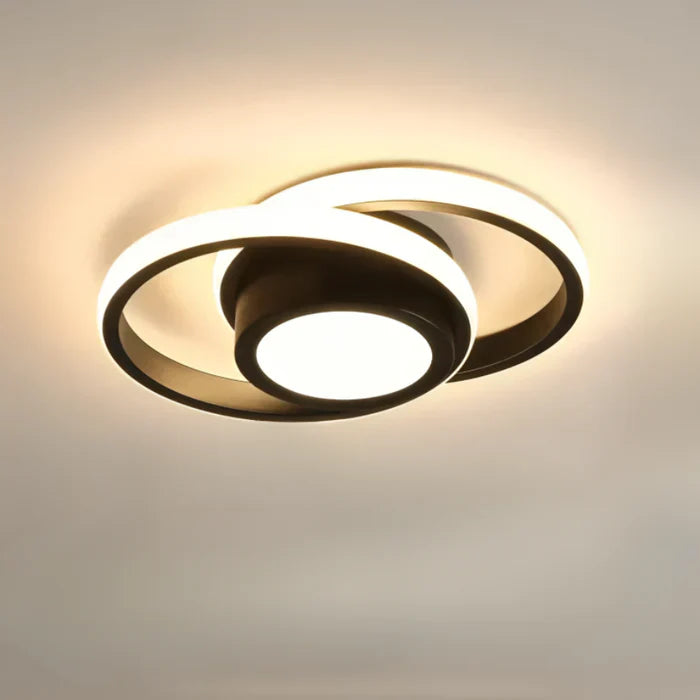 Wave black LED ceiling light with curved frame, ceiling-mounted in a hallway
