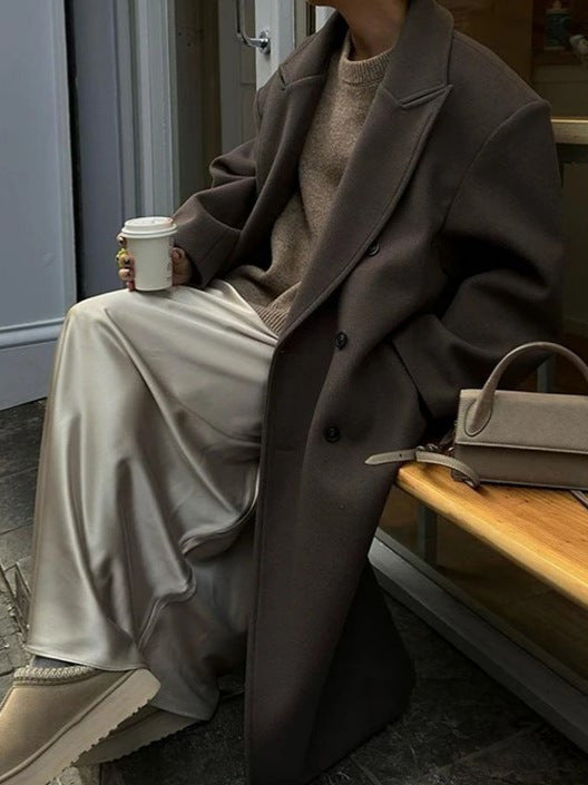 Women's long wool blend coat with wide lapels and double-breasted button closure, three-quarter view