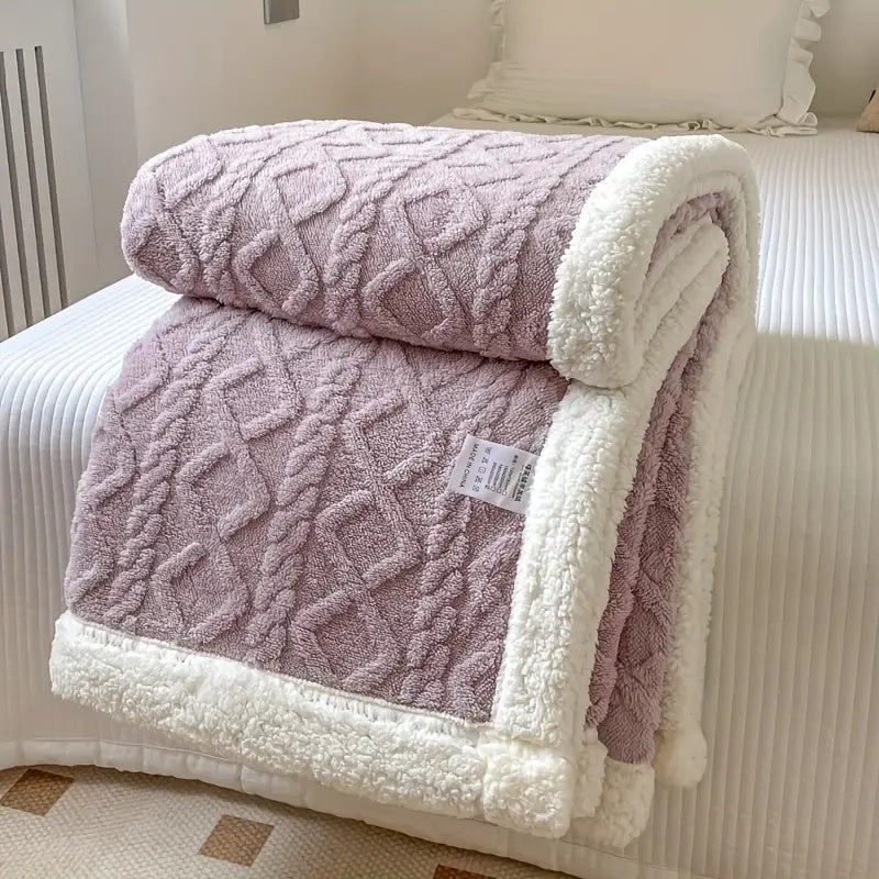 Plush sherpa blanket folded to show layered thickness and cozy sherpa interior