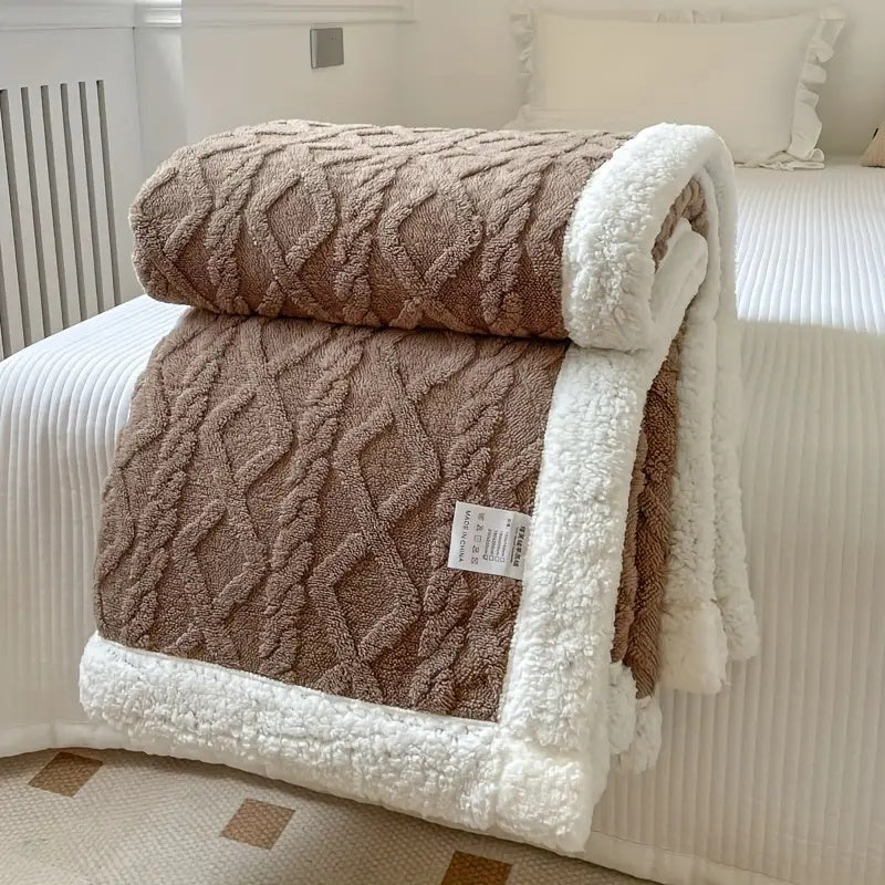 Reverse side of plush blanket showing thick sherpa lining for added warmth and comfort