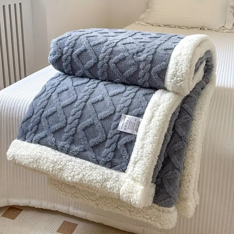 Plush sherpa blanket neatly folded, showing product presentation and fabric quality