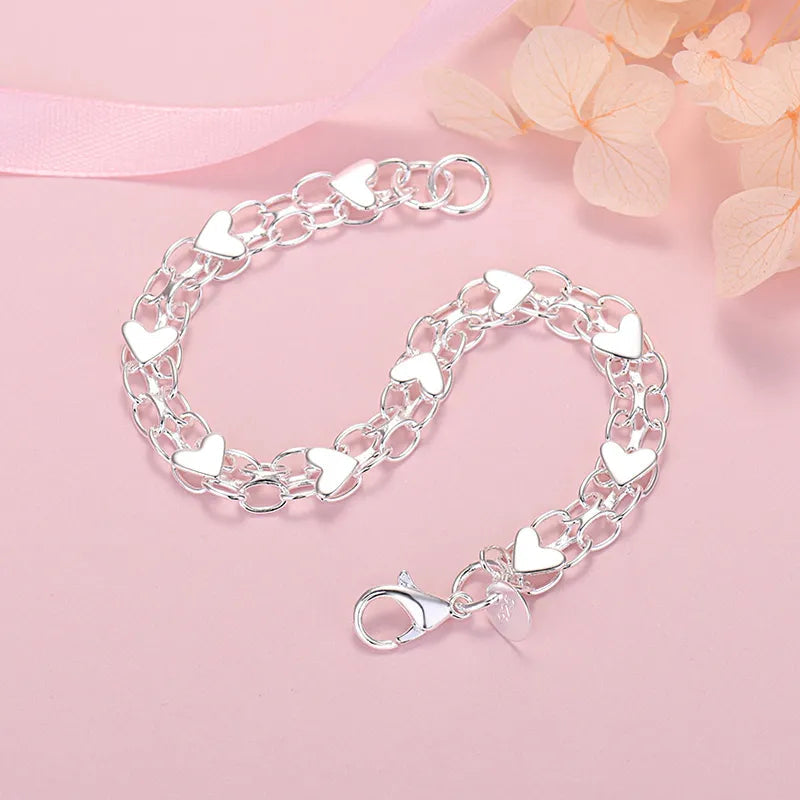 Women's metal bracelet with heart-shaped linked chain and lobster clasp