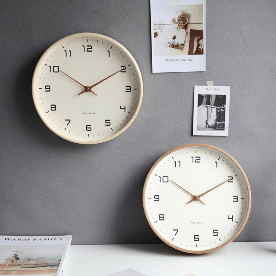 Close-up of minimalist wall clock with wood frame and simple hour markers